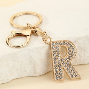 Detailed view of golden letter R keychain with sparkling white rhinestones and clasp