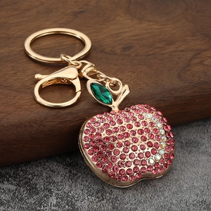 Apple keychain pendant with pink rhinestones and green crystal leaf on gold plating