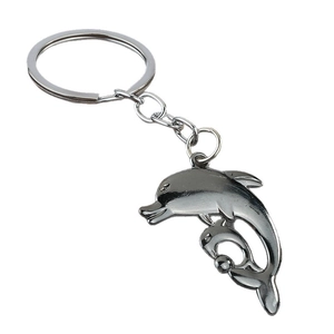 Polished silver dolphin keychain with mother and child pendant on white background