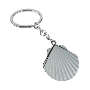 Polished silver shell keychain pendant made of metal with radial stripe texture on white