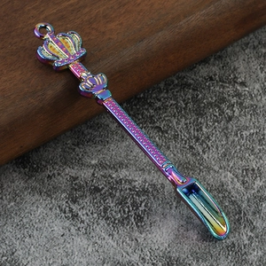 Rainbow plated crown top metal mini spoon with anti-slip handle on a stone background