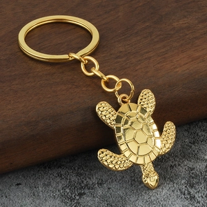 Golden alloy turtle keychain featuring detailed hexagonal shell patterns and sturdy metal link