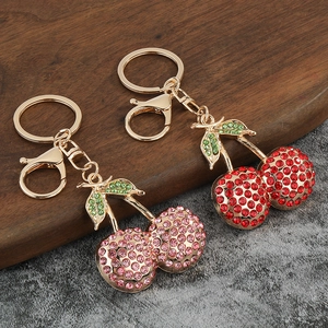 Sparkling cherry keychains with pink and red rhinestones on a gold metal base