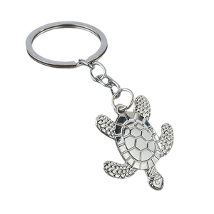 Silver metal sea turtle keychain with realistic shell texture and polished finish on white background