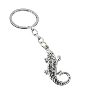 Silver crocodile metal keychain with detailed scale textures on white background