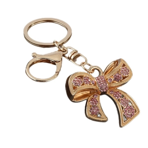 Sparkling pink rhinestone bow keychain with golden alloy plating and lobster clasp