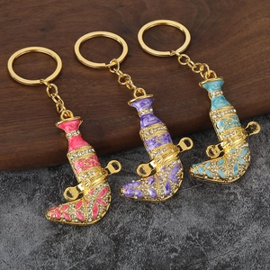 Detailed view of colorful enamel and crystal encrusted Jambiya dagger keychains