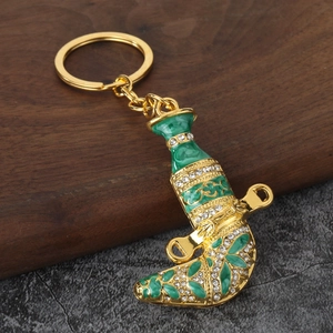 Exquisite gold Arabian Jambiya dagger keychain with green enamel and sparkling rhinestones