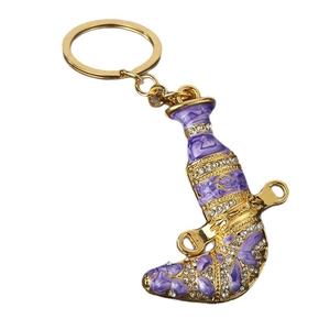 Golden Khanjar dagger keychain with purple enamel coating and white rhinestones
