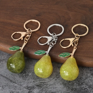 Cute resin pear keychains in green and yellow colors with glitter and leaf charms