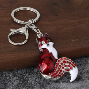 Detail of red enamel fox keychain with sparkling crystals and silver lobster clasp