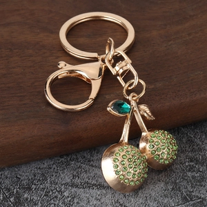 Sparkling cherry keychain with green rhinestones and golden metal ring for women