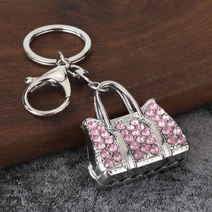 Close-up of silver alloy handbag keychain with pink rhinestones and lobster clasp detail
