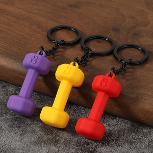 Detailed view of red, yellow and purple dumbbell keychains with 45 LB embossed weight
