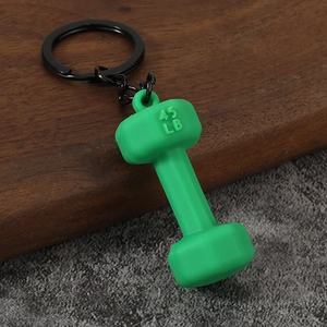 Close-up of a green dumbbell keychain with 45 LB engraving and black metal chain