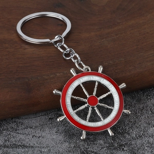 Détail d'un porte-clés de gouvernail nautique avec émail rouge et blanc sur bois
