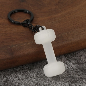 Detailed close-up of a 45 LB dumbbell keychain with matte white finish and black metal ring