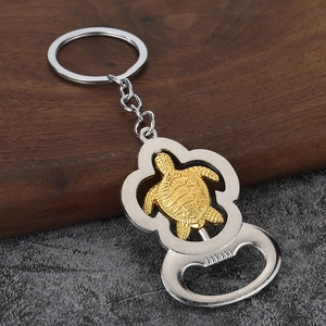 Silver marine turtle keychain with a rotating golden turtle and integrated beer bottle opener