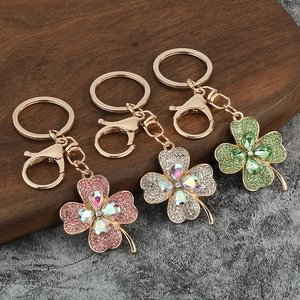 Luxury rhinestone clover keychains in pink, white, and green with crystal details