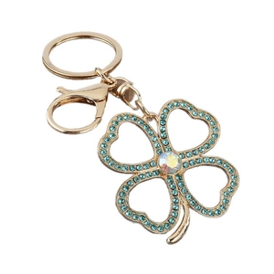 Golden clover keychain with blue rhinestones and AB crystal center on white background