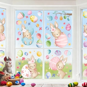 Close-up of Easter window clings with cartoon rabbits and colorful eggs on glass