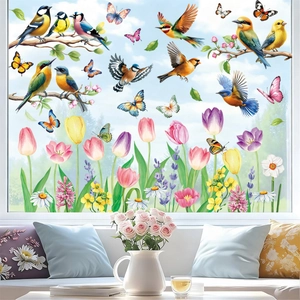 Vivid hummingbird and butterfly window clings on bright glass with home decor