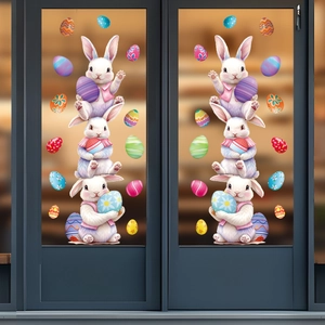 Close-up of Easter window stickers with cartoon rabbits holding colorful eggs on glass