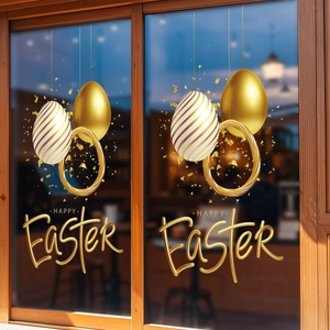 Detail of gold and white Easter egg stickers with Happy Easter text on a window