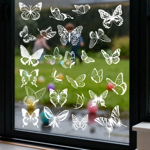 Detailed view of white butterfly silhouette window decals for collision prevention