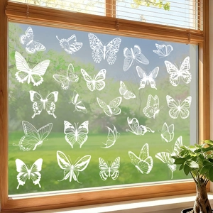 Set of 24 white butterfly window clings on glass with a scenic garden background