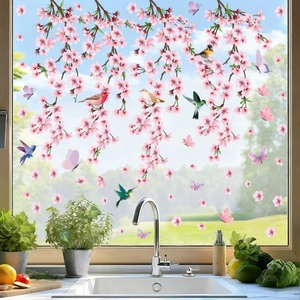 Detailed kitchen window view of pink cherry blossom stickers with birds and butterflies