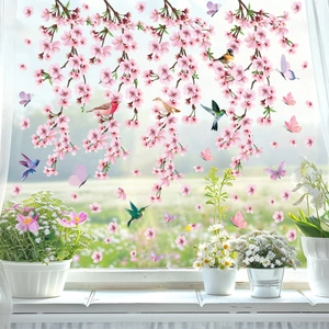Detail of pink cherry blossom stickers and birds applied to a bright glass window display