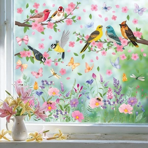 Colorful bird and butterfly static window decals on a glass pane with floral accents