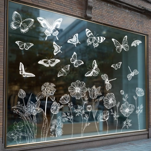 White butterfly and floral static window clings displayed on a glass shop storefront