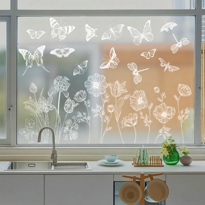 Detail of white butterfly and floral static stickers on a glass kitchen window