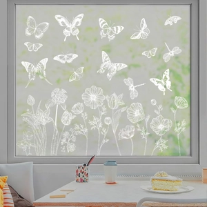 Detail of white butterfly and floral static window stickers on transparent glass pane