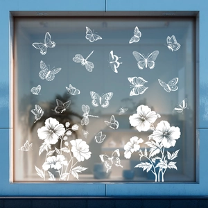 Detailed view of white butterfly and flower static window decals on glass surface