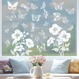 Close-up of white butterfly and flower static window stickers in a bright sunlit room