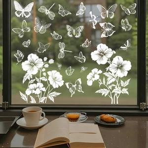 Detailed view of white butterfly and floral static window clings on a glass pane