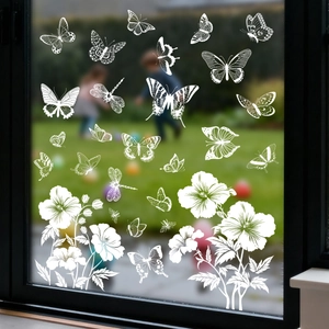 White static butterfly and floral window decals on glass with garden background