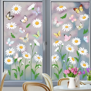 Detailed view of spring butterfly and daisy window stickers on glass in a cozy sunroom