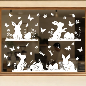 Detail of white cartoon bunny and Easter egg window decals on a wooden glass frame