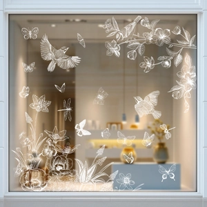 White floral and butterfly window stickers with fine hand-drawn lines on glass