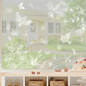 Spring window clings featuring white line floral butterflies and birds on glass