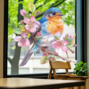 Decorative window sticker with colorful birds and pink cherry blossoms on clear glass