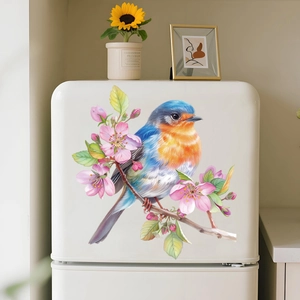 Close-up of bird and cherry blossom wall decal on a white refrigerator door