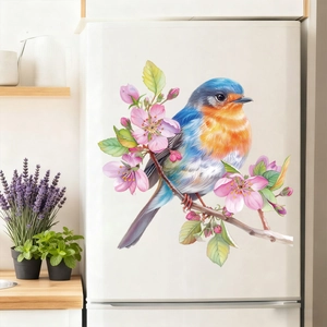 Detail of floral and bird decal applied to a modern white refrigerator in a bright kitchen