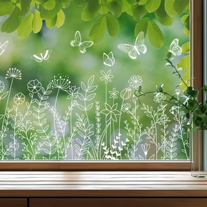 Close-up of white flower and butterfly static window stickers on glass surface