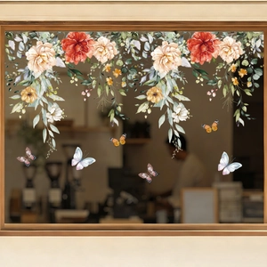 Close-up of watercolor floral window decals with blooming peonies and butterflies