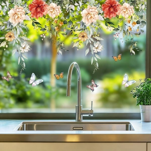 Close-up of floral wall stickers with butterflies on a transparent glass window surface